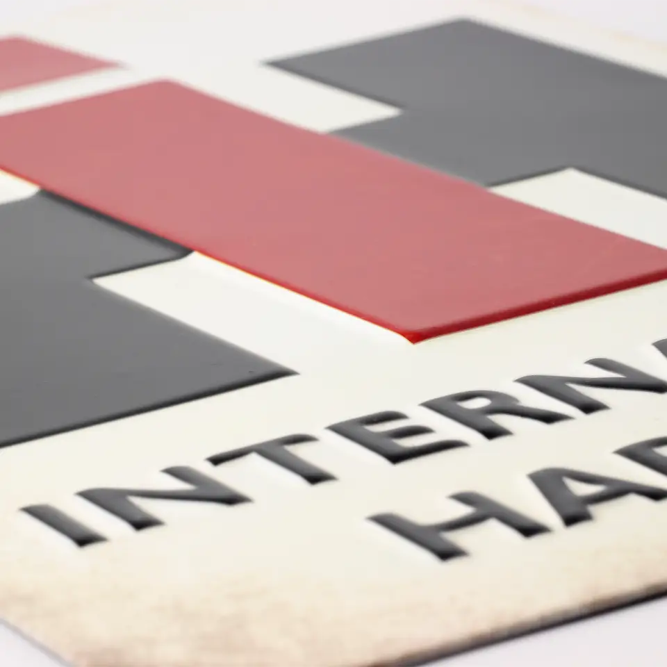 International Harvester embossed metal sign close up view