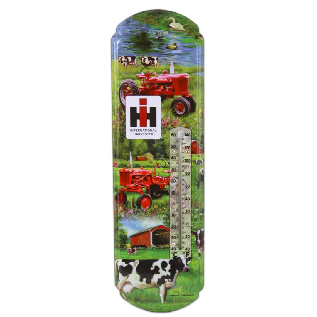 Vintage metal thermometer featuring a red IH Farmall C tractor on a farm scene with barns, animals, and International Harvester logo.
