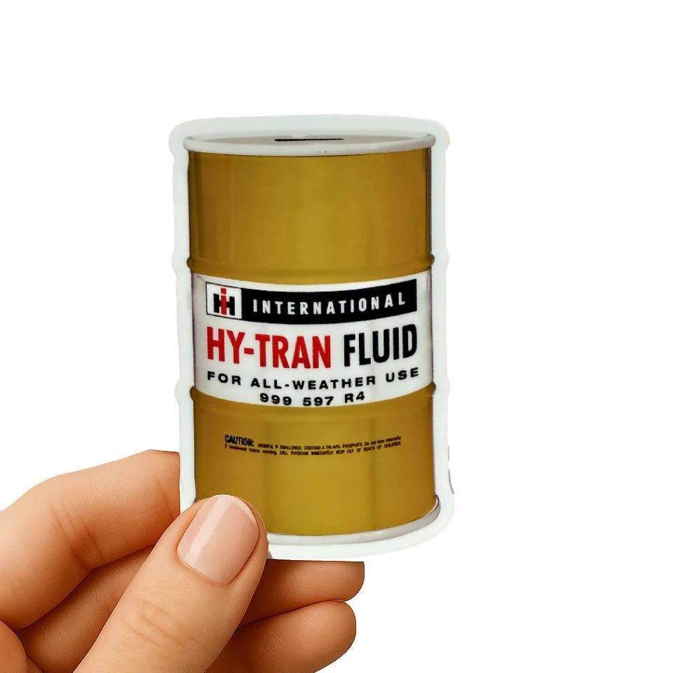 Vintage-style International Harvester HY-TRAN Fluid drum sticker held in hand, ideal for Farmall fans, vintage tractor collectors, and rural lifestyle enthusiasts.