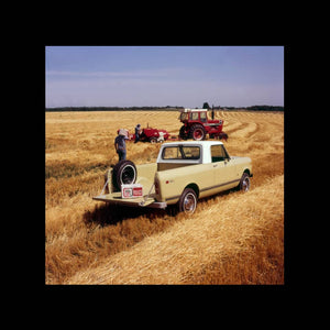 International Harvester Scout in the field with tractor